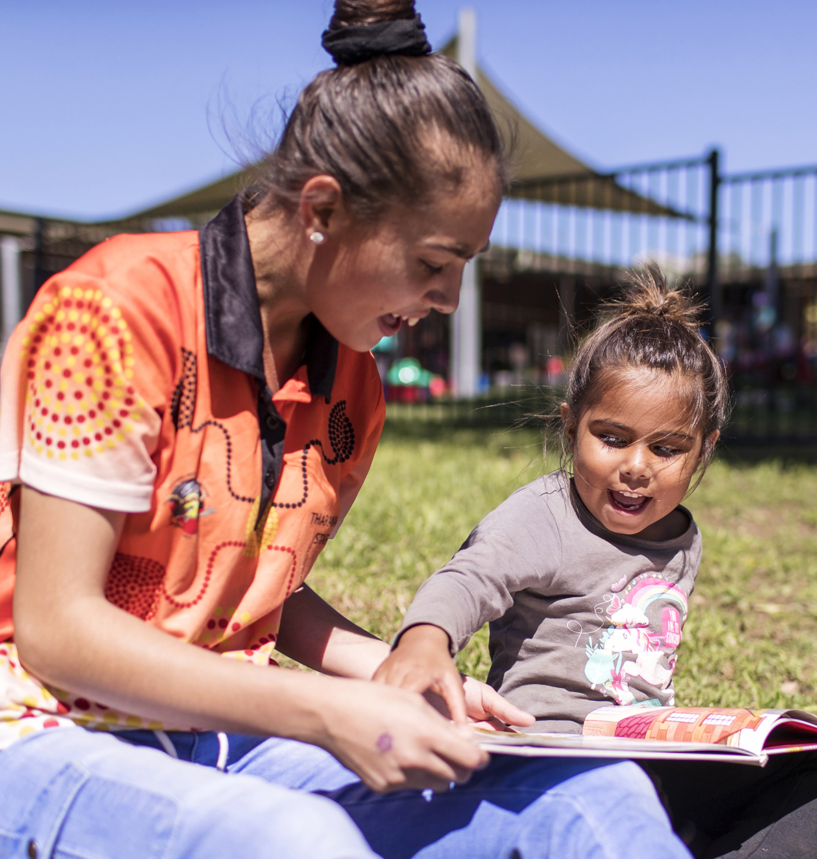 Child reading with adult